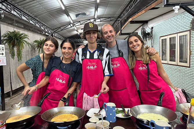 Authentic Thai Cooking Class and Farm Visit in Chiang Mai - Cooking in an open-air kitchen