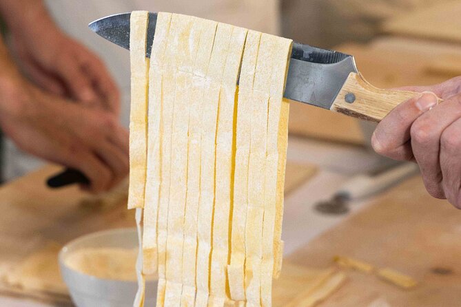 Fettuccine, Ravioli, and Tiramisu Cooking Class in Rome - Kneading egg dough for fettuccine