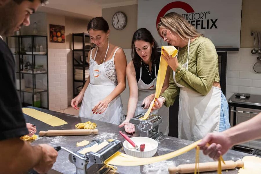 Florence: Handmade Pasta & Dessert Class with Unlimited Wine - Rolling dough by hand and using a pasta machine