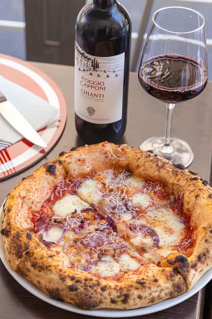 Florence: Private Pizza Making Class with Wine Tasting - Adding sauce and shaping your pizza