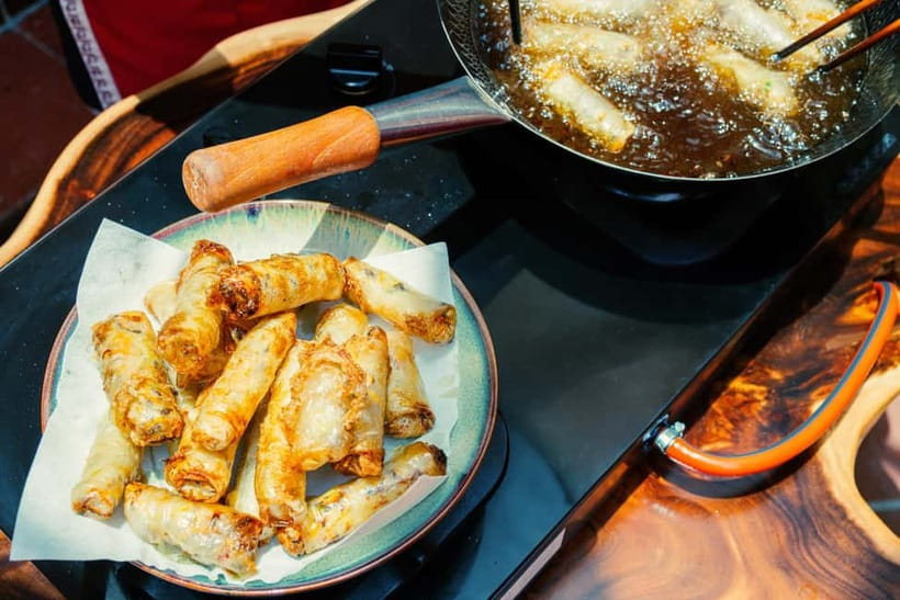 Hanoi Cooking Class: Market Tour, Free Recipe & Beverages - Eating the food you just made