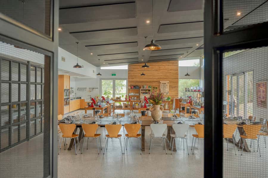 Maggie Beer's Farm Hands-on Cooking School and Lunch - Putting on an apron and cooking a course