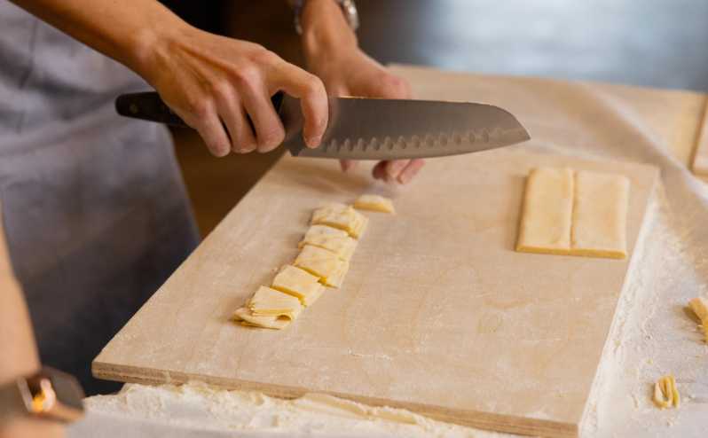 Masterclass: Aperol Spritz & Pasta Making Experience in Rome - Cutting rustic maltagliati with basil pesto