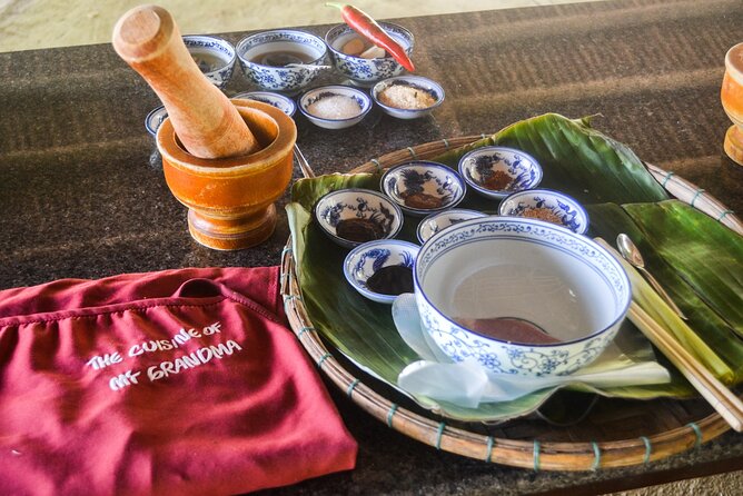 My Grandma's Home Cooking Class in Hoi An - Preparing pork, salad, and local fish